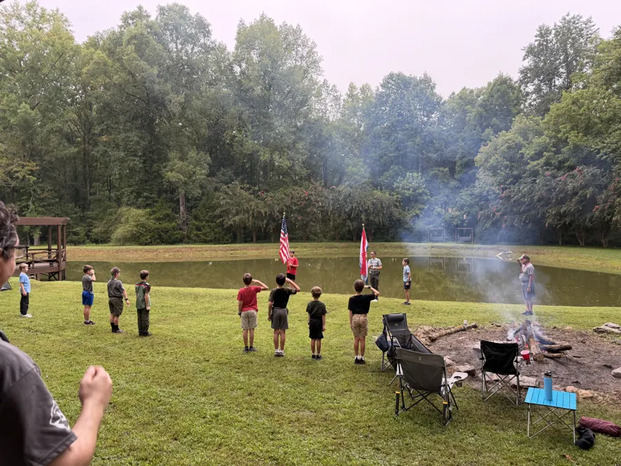 Troop members gathered outdoors near their camp at Raney